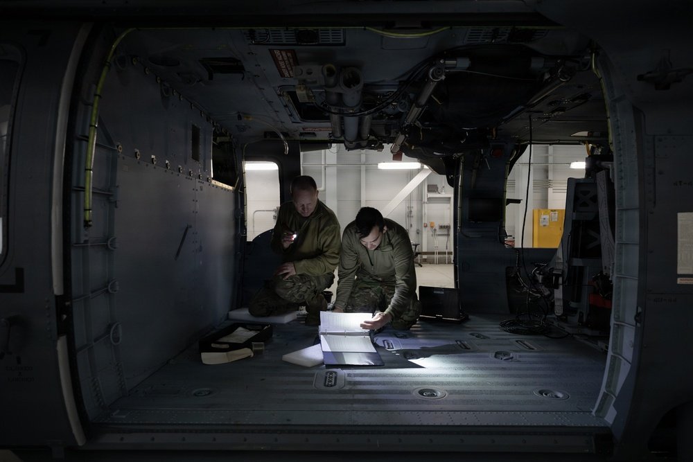 Aviation specialists reviewing technical documentation inside an aircraft
